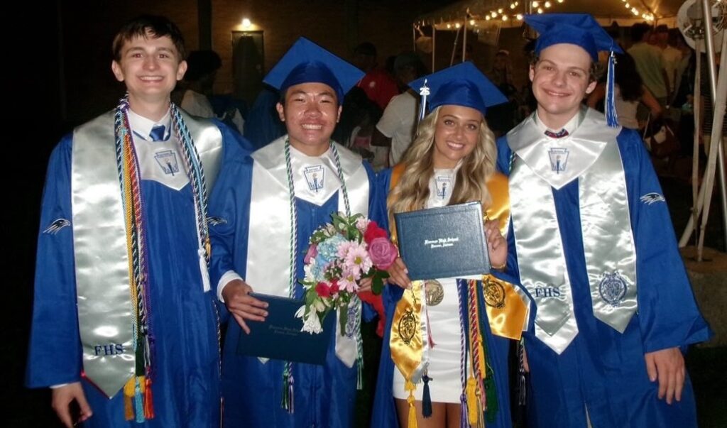 Camden Seal and three other Florence High School students pose in their graduation caps and gowns.